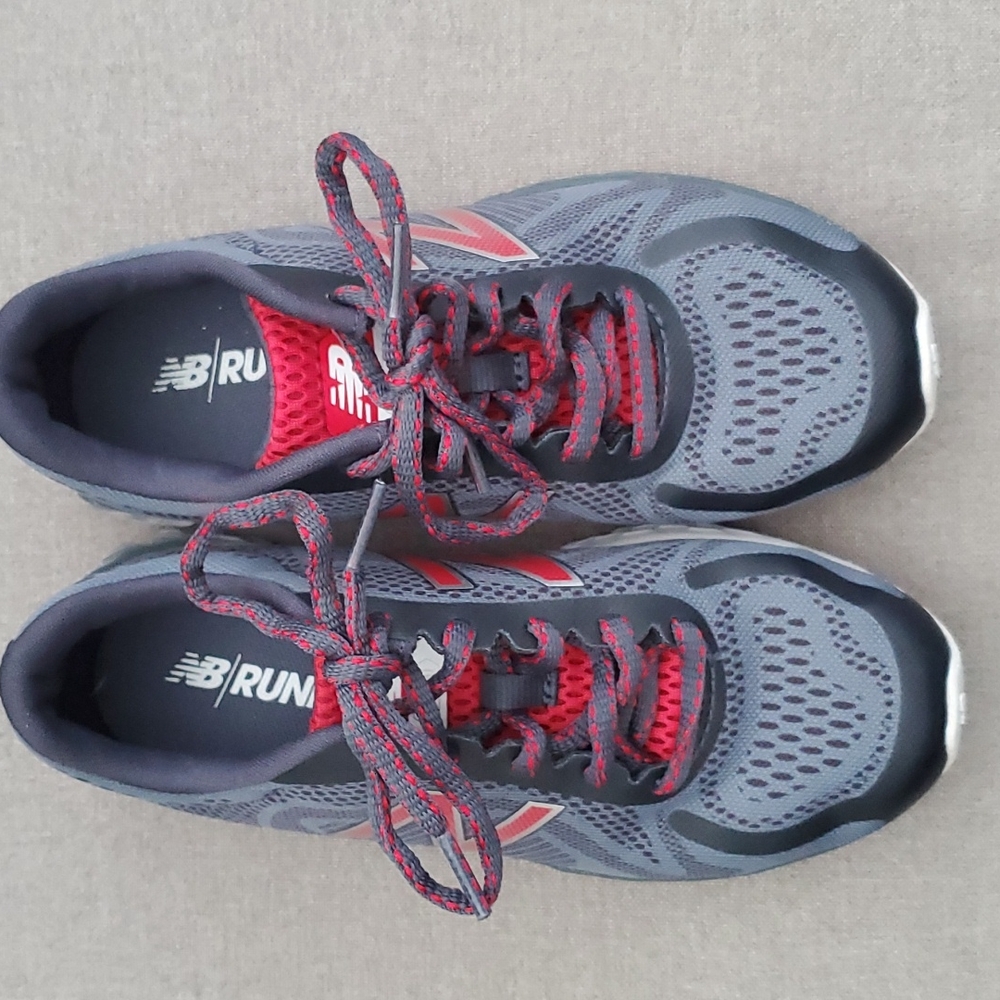 Like new boys New Balance Arishi running shoe. Black gray and red size 1.5